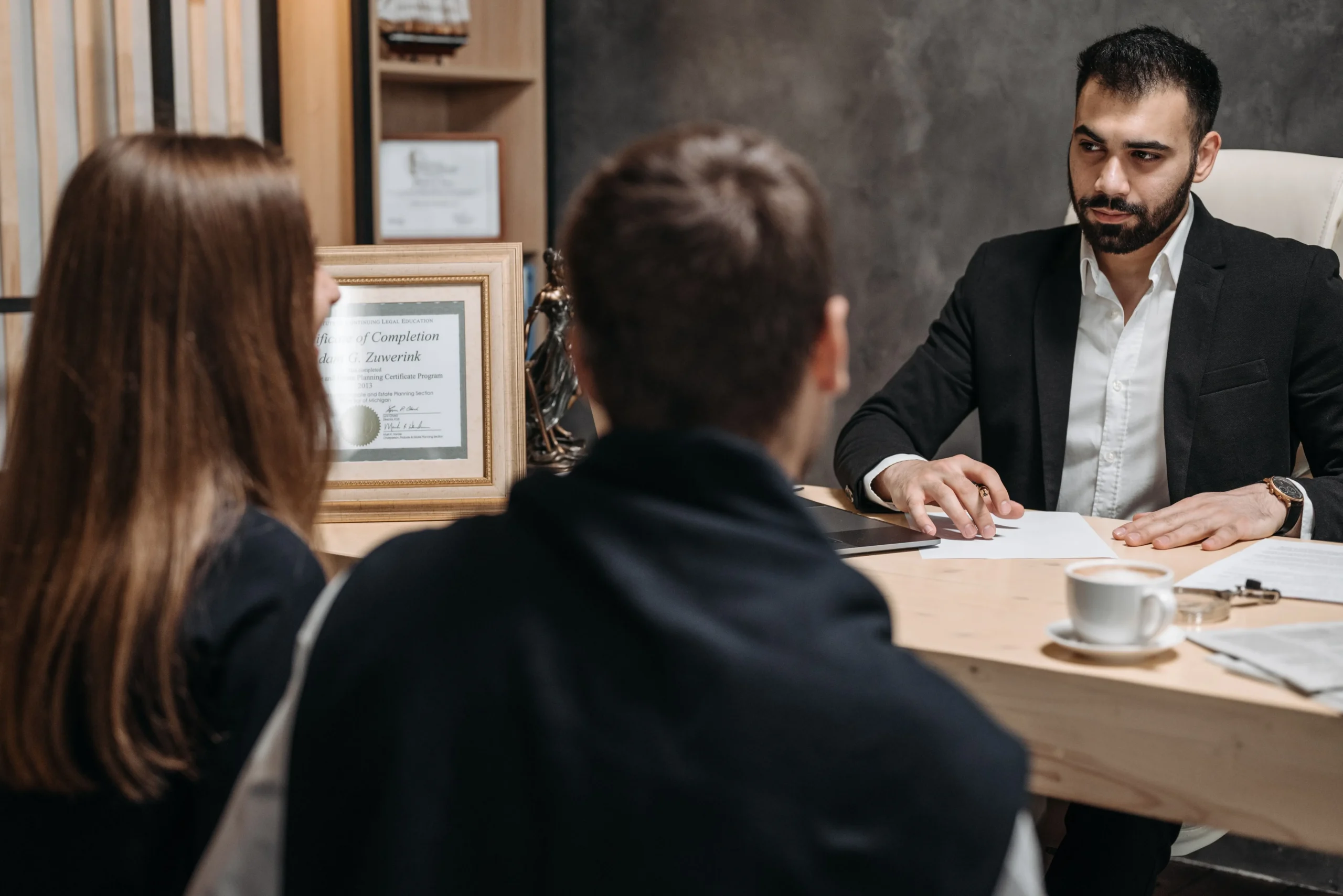 Personal injury attorney reviewing a filing deadline with clients in an office