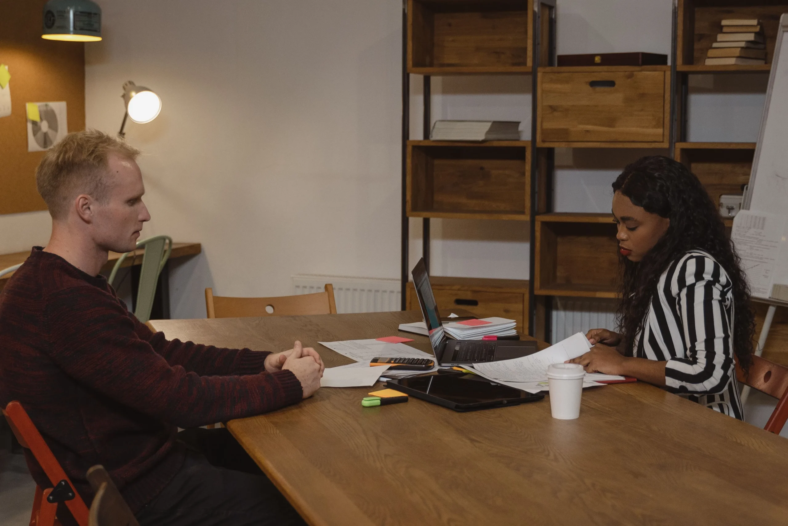 reporting-workplace-harassment-hr-meeting.webp Employee meeting with a manager at a table to report workplace harassment